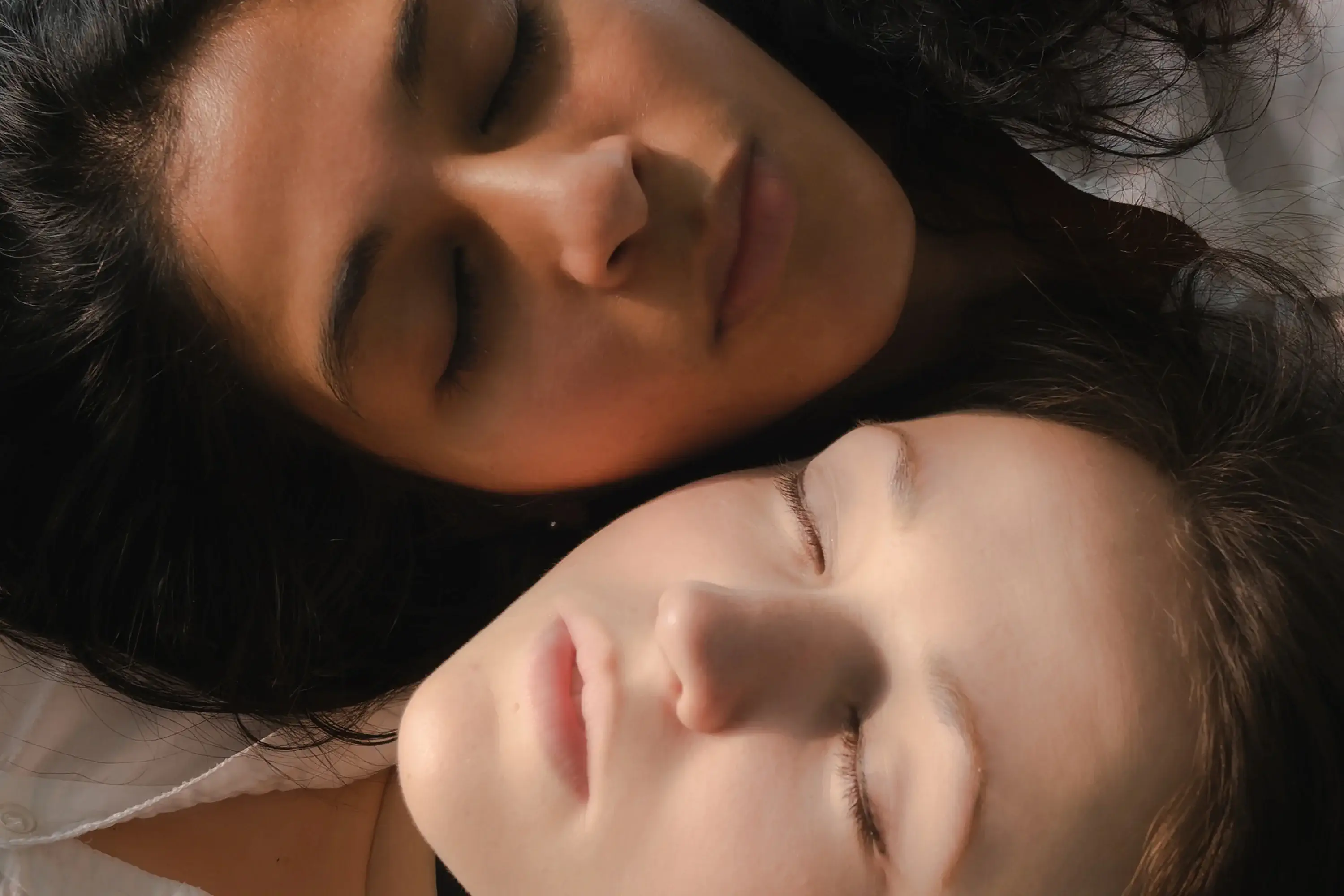 two women leaning heads next to each other